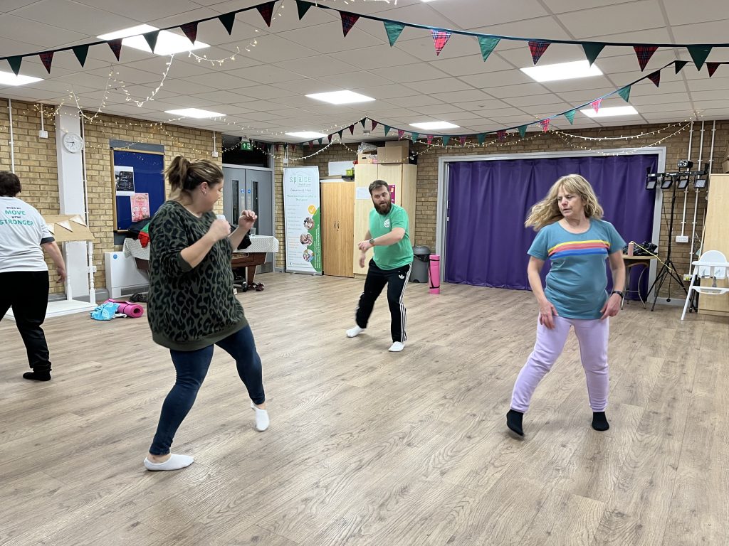 Four people dancing, all doing their own movement.